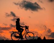 man riding bike during sunset