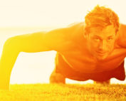 man doing pushups on grass