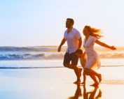 family running together on beach